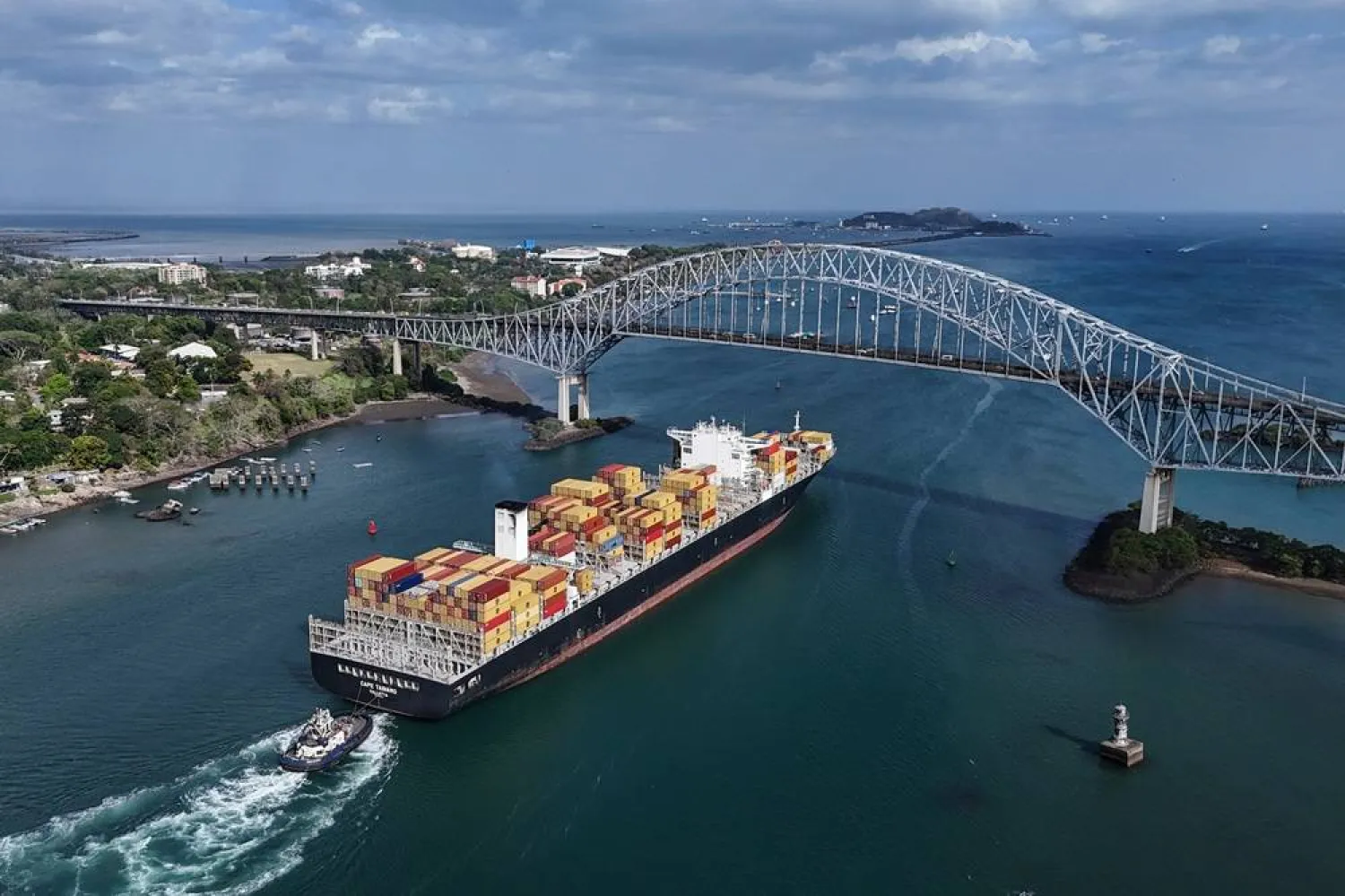 A cargo ship sails under Las Americas bridge through the Panama Canal, in Panama City, Thursday, March 12, 2026. (AP)