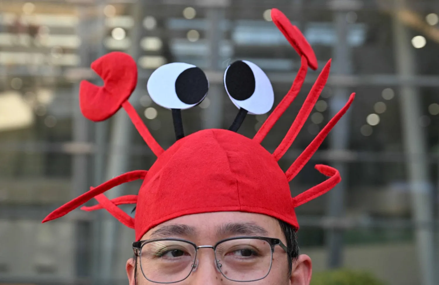 A man wears a lobster hat that represents the OpenClaw logo, an open-source AI assistant at the Baidu headquarters in Beijing on March 11, 2026. (Photo by ADEK BERRY / AFP)