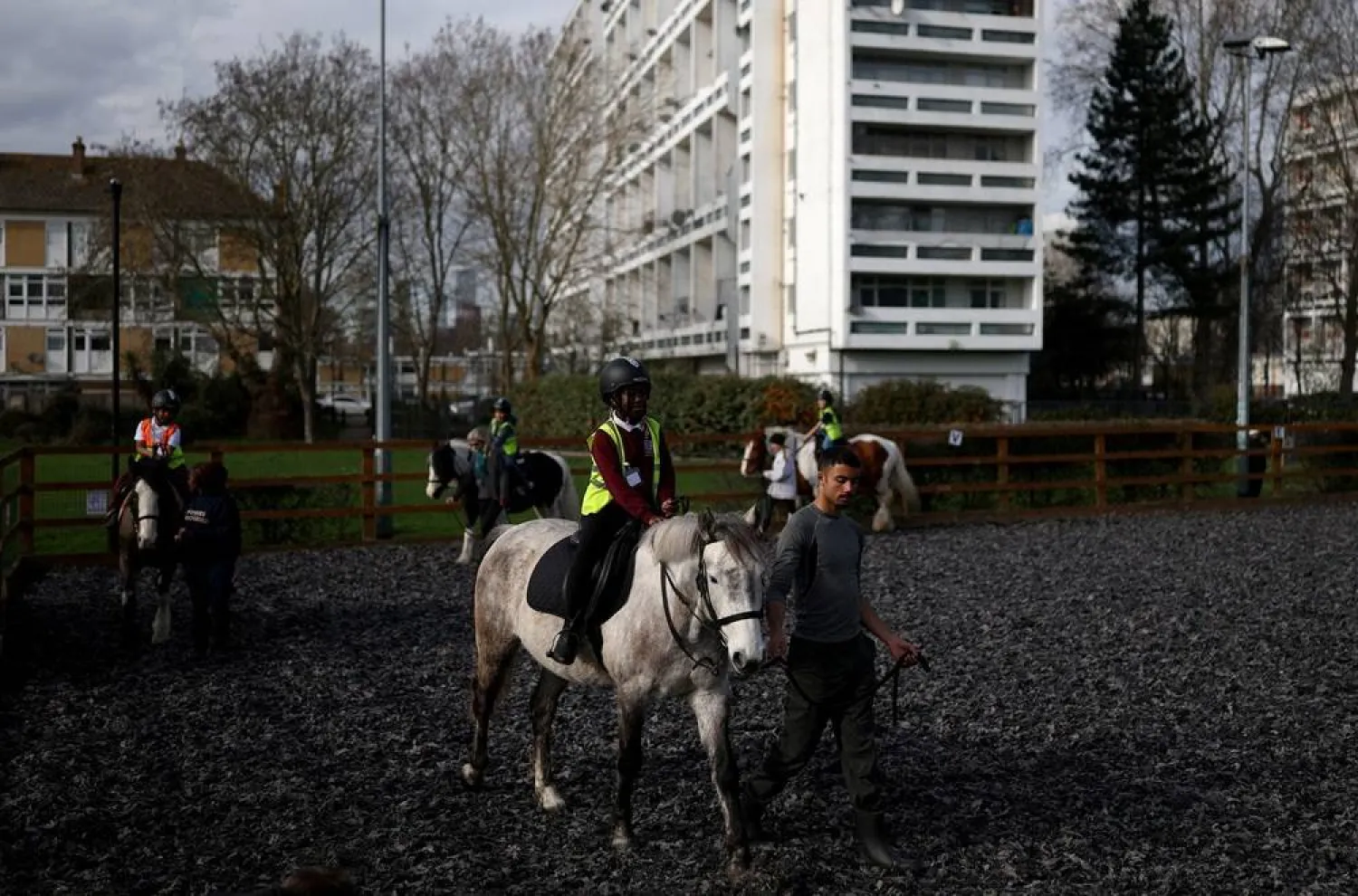 Children ride horses around a paddock during a class at the Ebony Horse Club in Brixton, Britain's most urban riding school, where children from under-privileged communities are taught to ride horses, in London, Britain, March 10, 2026. (Reuters)