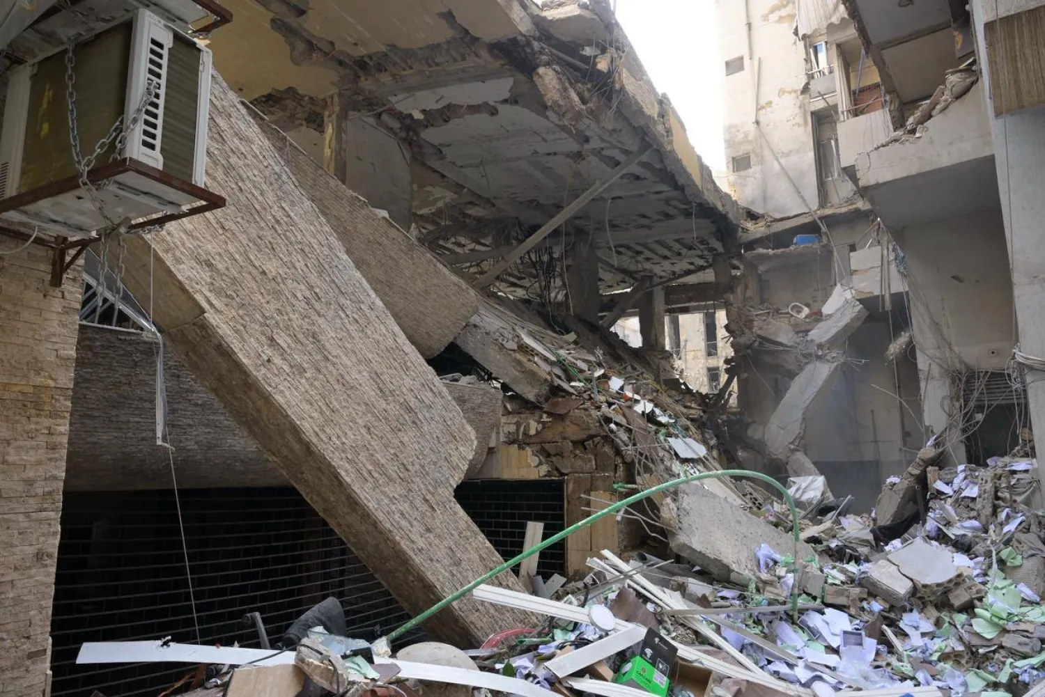 Part of the building struck by an Israeli air strike in the Bashoura area, where the Israeli military said Hezbollah stores money beneath it (Asharq Al-Awsat)