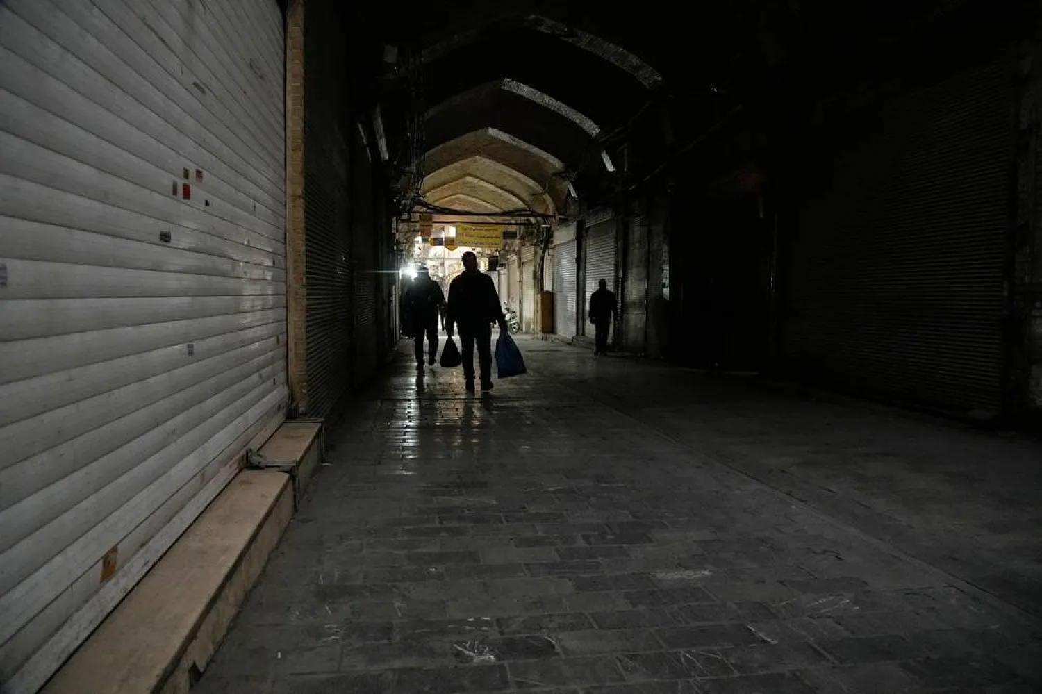  People walk past closed shops at the almost empty traditional main bazaar, in Tehran, Iran, Tuesday, March 10, 2026. (AP) 