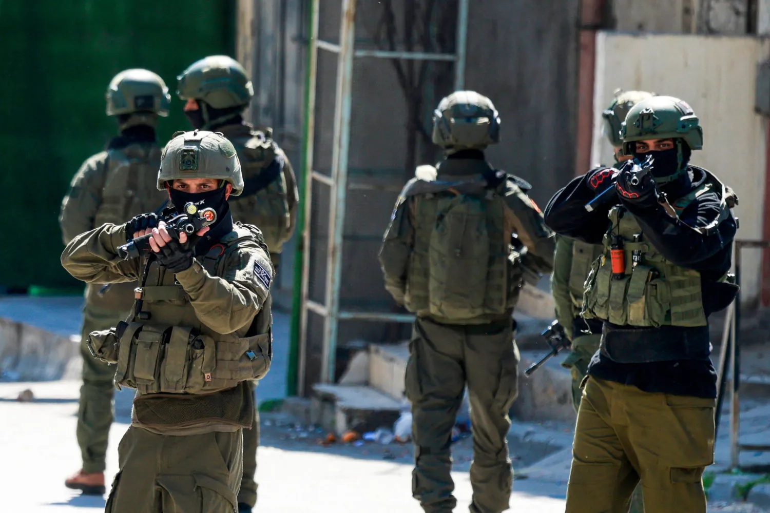 TOPSHOT - Israeli soldiers patrol a street during a military operation in the Askar refugee camp in eastern Nablus, Israeli-occupied West Bank, on March 2, 2026. (Photo by Jaafar ASHTIYEH / AFP)