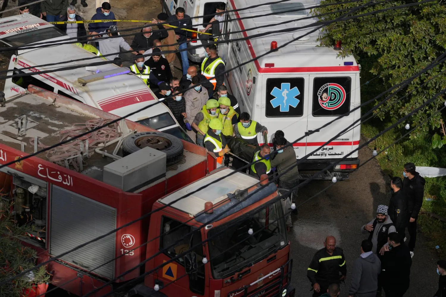 Rescue workers carry a body from an apartment destroyed in an Israeli airstrike in the southern port city of Sidon, Lebanon, Saturday, March 14, 2026. (AP Photo/Mohammad Zaatari)