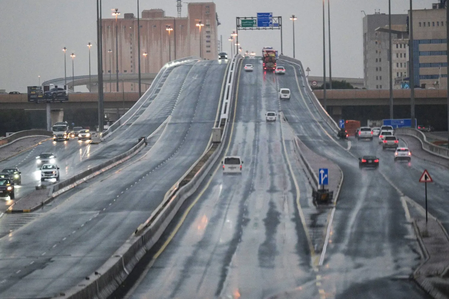 Vehicles drive along a highway during a heavy rain in Kuwait City on March 12, 2026. (Photo by YASSER AL-ZAYYAT / AFP)