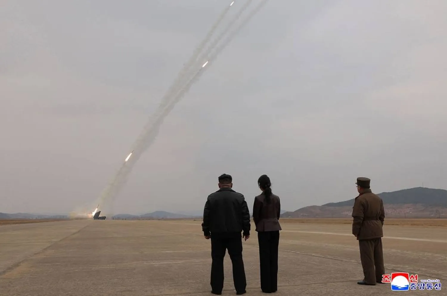 This picture taken on March 14, 2026 and released by North Korea's official Korean Central News Agency (KCNA) via KNS on March 15, 2026 shows North Korean leader Kim Jong Un and his daughter Kim Ju Ae observing a training exercise of North Korean Army's 600mm-caliber ultra-precision multiple rocket launchers, at an undisclosed location in North Korea. (KCNA via KNS / AFP) 