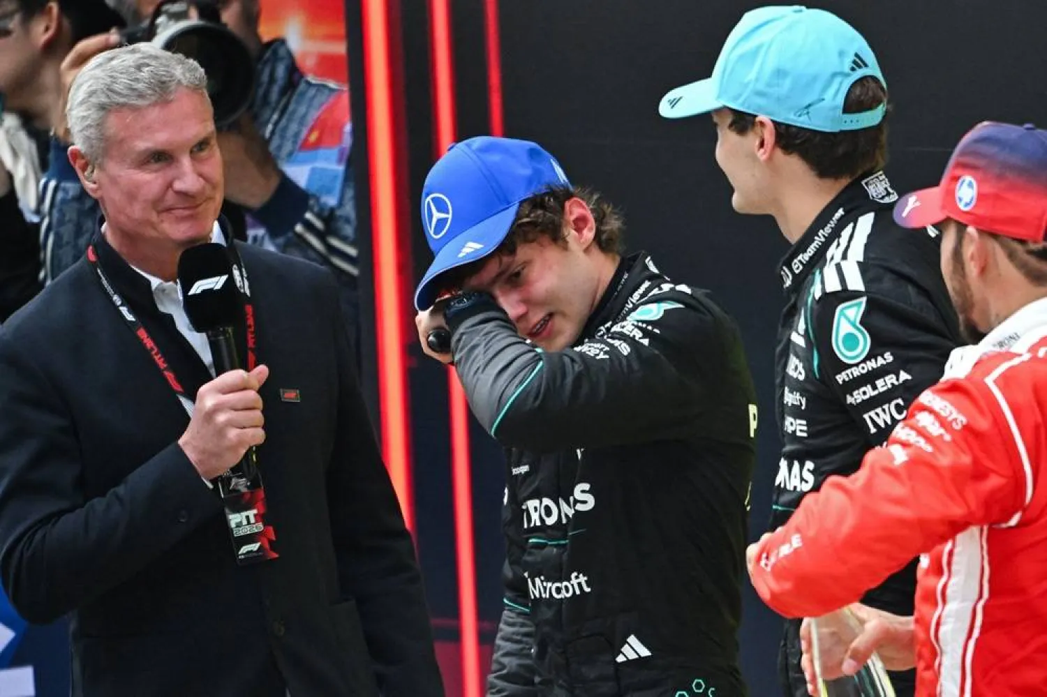 First-placed Mercedes' Italian driver Kimi Antonelli (2L) celebrates winning alongside Mercedes' British driver George Russell (2R) and Ferrari's British driver Lewis Hamilton (R) after the Formula One Chinese Grand Prix at the Shanghai International Circuit in Shanghai on March 15, 2026. (AFP)