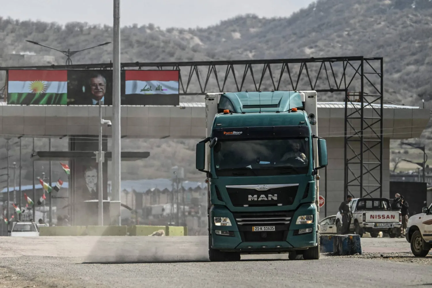 A truck drives at the Iraq-Iran border crossing of Bashmagh near Sulaimaniyah in Iraq's autonomous Kurdistan region on March 11, 2026. (AFP)
