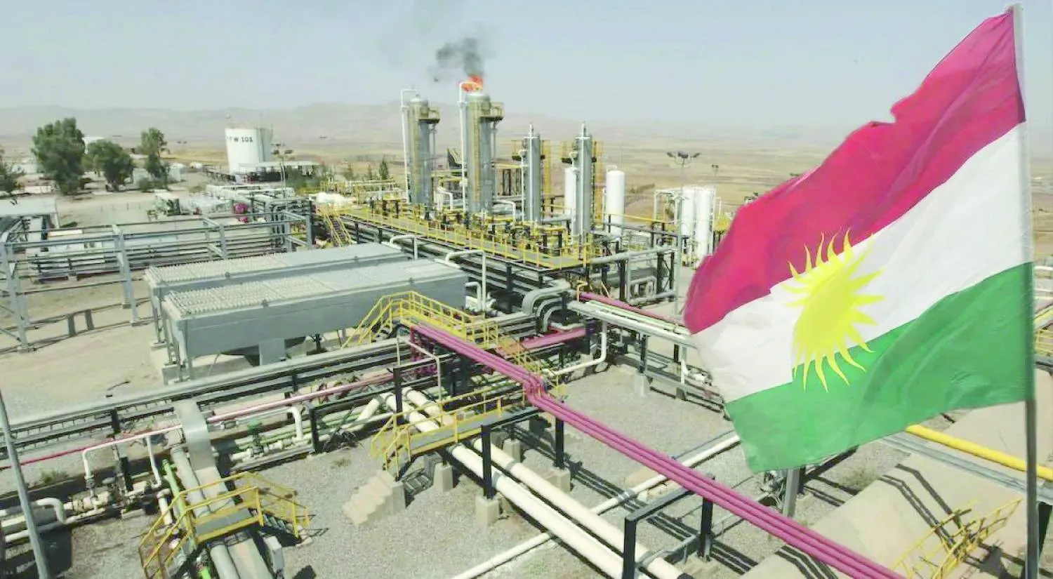 علم كردستان العراق أمام حقل نفط في الإقليم (رويترز)