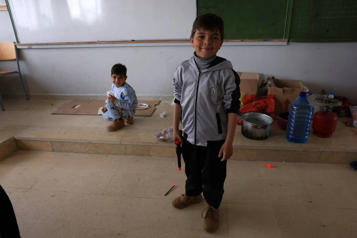  A child poses for a photo, at a school hosting displaced people, following an escalation between Hezbollah and Israel, amid the US-Israeli conflict with Iran, in Lebaa, Lebanon, March 15, 2026. (Reuters)