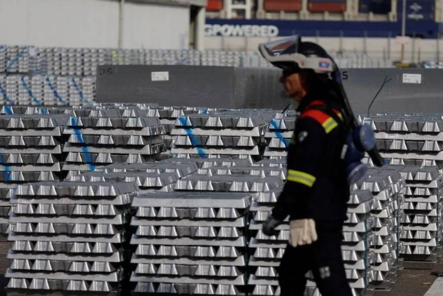 A worker walks past the storage of aluminium ingots at the aluminum smelter Aluminium Dunkerque in Loon-Plage near Dunkirk, France, September 22, 2022. REUTERS/Pascal Rossignol