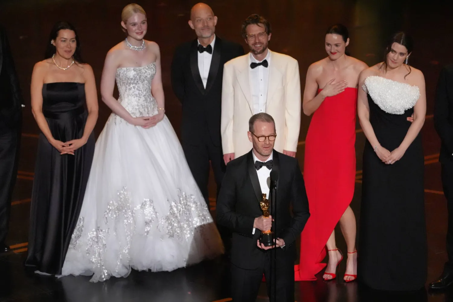 Maria Ekerhovel, from left, Elle Fanning, Joachim Trier, center, Eskil Vogt, Anders Danielsen Lie, Renate Reinsve, and Inga Ibsdotter Lilleaas accept the award for interntional feature film for "Sentimental Value" during the Oscars on Sunday, March 15, 2026, at the Dolby Theatre in Los Angeles. (AP Photo/Chris Pizzello)