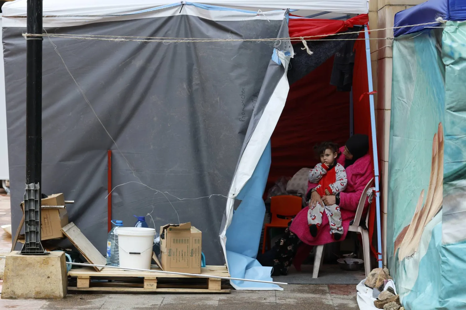 A displaced woman and a child sit in a tent in downtown Beirut, Lebanon, 15 March 2026.  EPA/WAEL HAMZEH