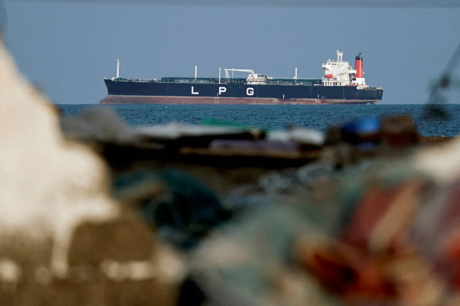 FILE PHOTO: An LPG gas tanker at anchor as traffic is down in the Strait of Hormuz, amid the US-Israeli conflict with Iran, in Shinas, Oman, March 11, 2026. REUTERS/Benoit Tessier/File Photo
