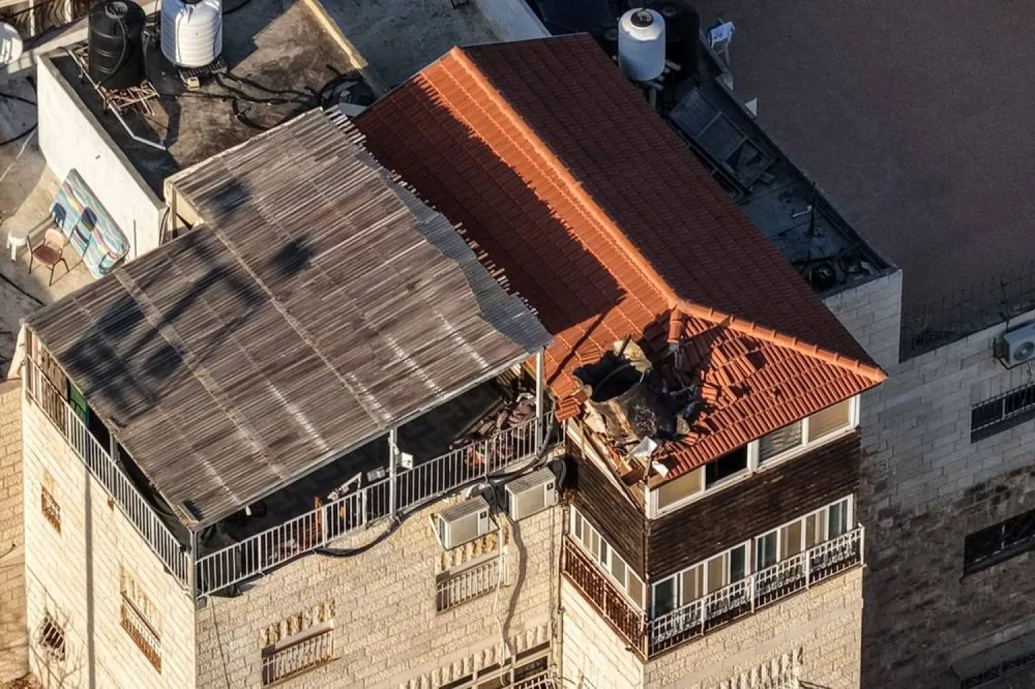  A drone view shows part of an Iranian missile that landed on a building's roof, amid the US-Israel conflict with Iran, in East Jerusalem March 16, 2026. (Reuters)