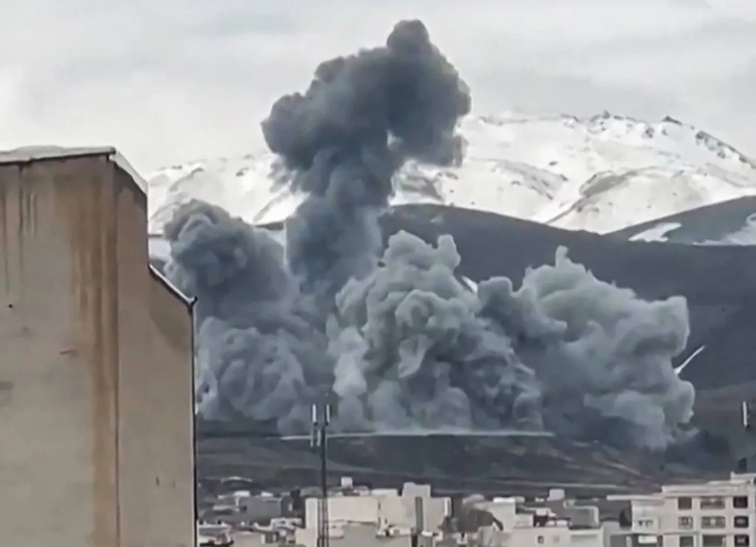 This video grab taken from UGC images posted on social media and verified by AFPTV staff on March 16, 2026, show smoke rising from the side of a mountain in Hamedan, in Hamedan Province, western Iran. (Photo by UGC / AFP) 