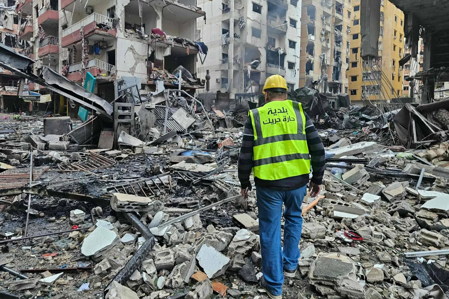A man inspects a site of overnight Israeli airstrikes in the southern suburbs of Beirut on March 16, 2026. (Photo by AFP) / 