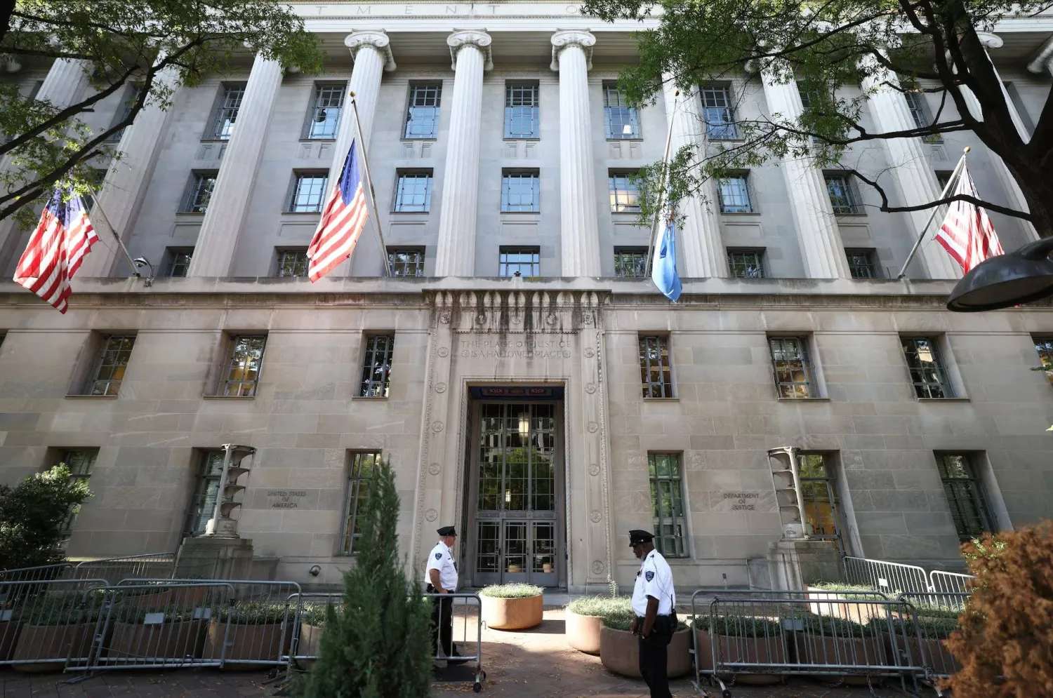 Officers keep watch outside the Department of Justice building in Washington, D.C., US, September 23, 2025. REUTERS/Kevin Lamarque Purchase Licensing Rights