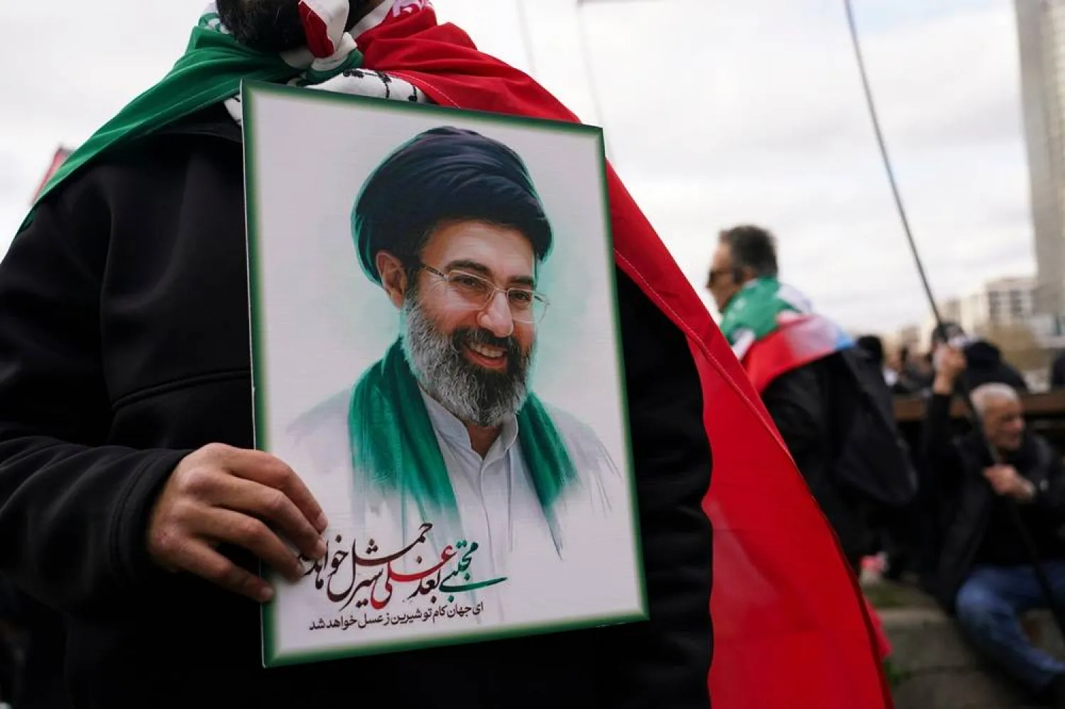  A demonstrator holds a portrait of the Mojtaba Khamenei during the Quds day in London, England, Sunday, March 15, 2026. (AP) 