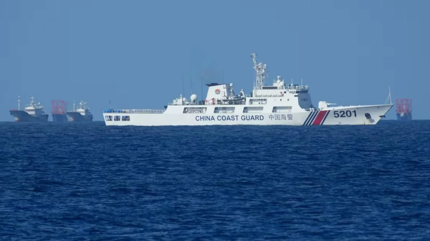A Chinese coast guard vessel stays beside suspected Chinese militia ships near Thitu island, locally called Pag-asa Island on November 6, 2024 ahead of a Philippine military multi-service joint exercise at the disputed South China Sea, Philippines. (AP) 