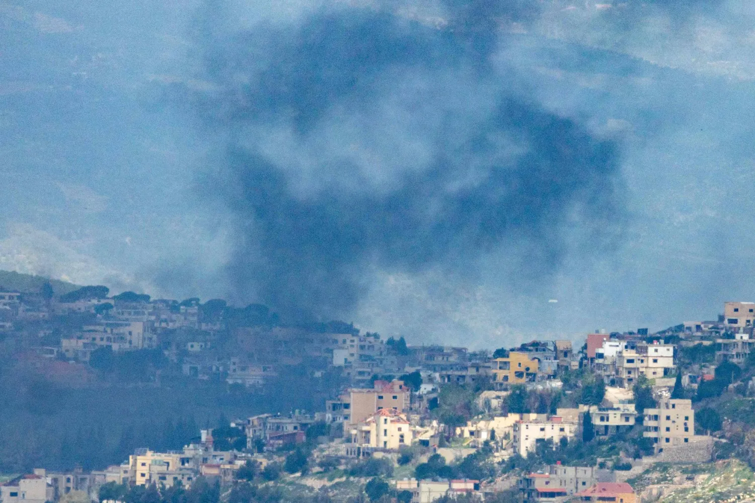 Smoke rises from the Lebanese village of Khiam after an Israeli strike as seen from the Upper Galilee in northern Israel on March 16, 2026.  (Photo by Odd ANDERSEN / AFP) / 