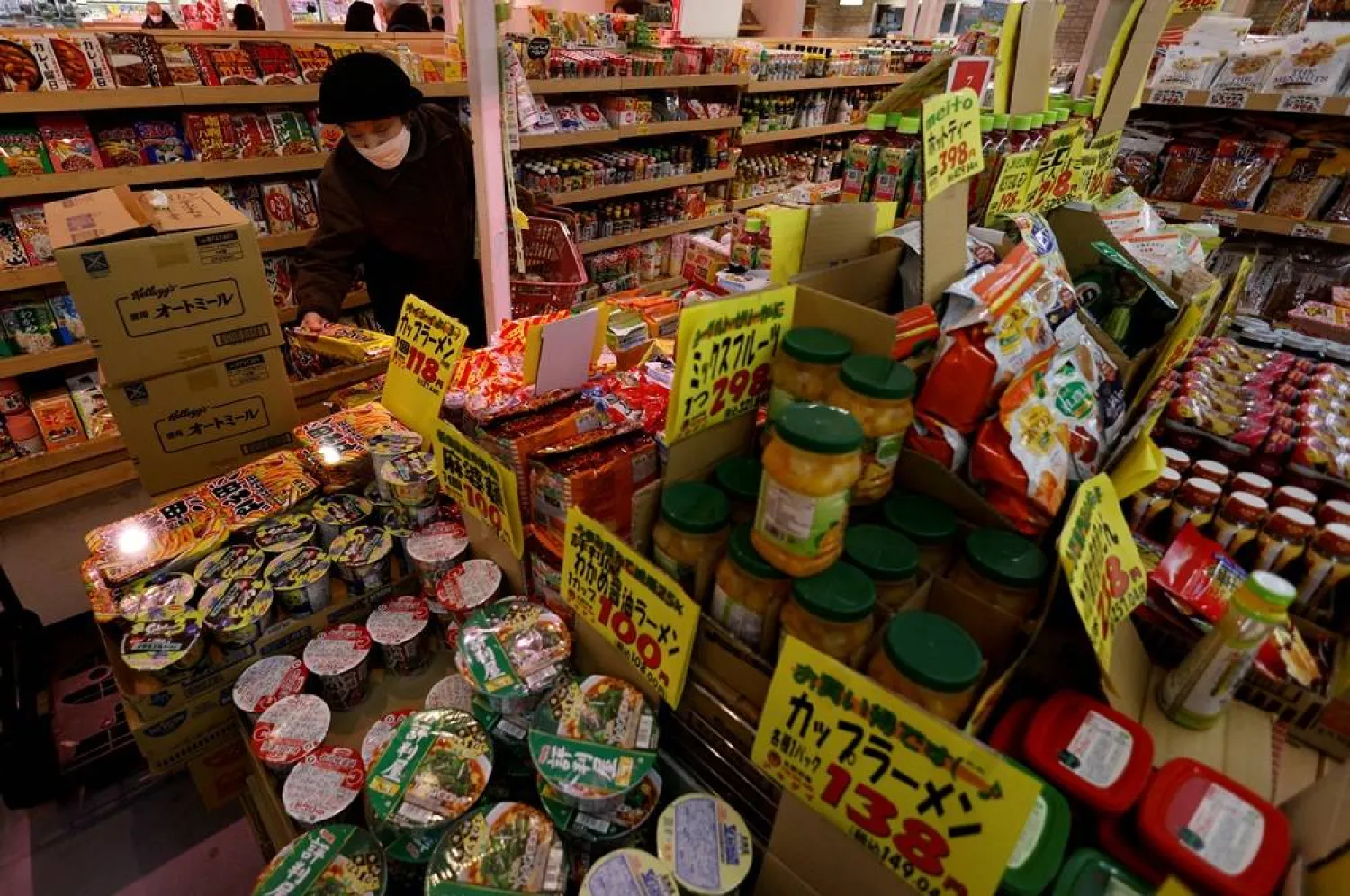 A shopper checks food items at a supermarket in Tokyo, Japan January 20, 2023. (Reuters)