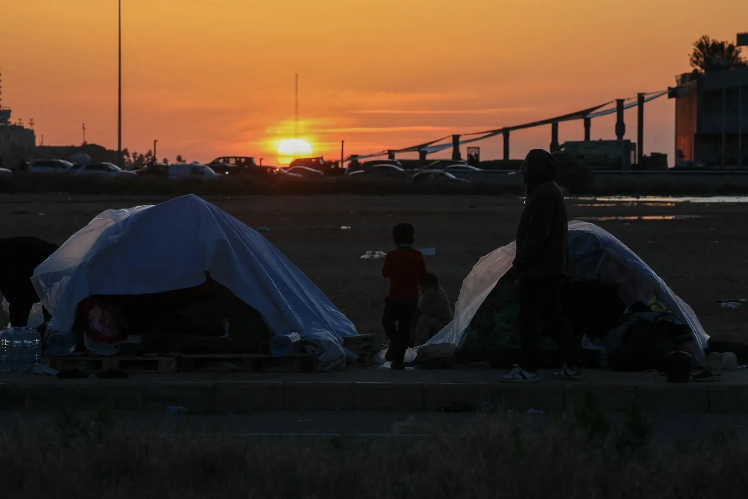  A displaced stands by tents, which have plastic sheeting to protect against rain, following an escalation between Hezbollah and Israel, amid the US-Israeli conflict with Iran, in Beirut, Lebanon, March 17, 2026. (Reuters)