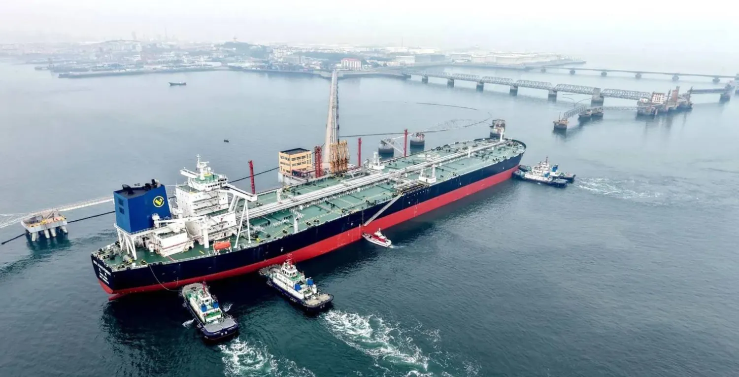 A crude oil tanker is guided to a berth at the oil terminal at the port in Qingdao, in China’s eastern Shandong province on 7 March 2026 (AFP)