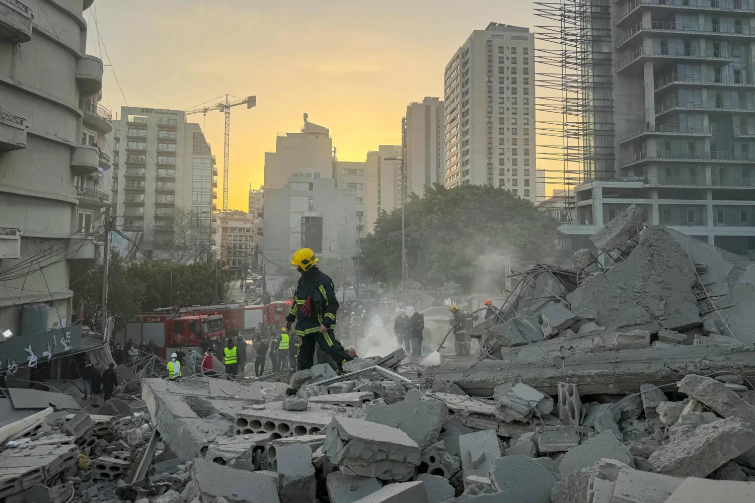 A firefighter walks past rubble at the site of an Israeli airstrike in Beirut's Bashoura neighborhood on March 18, 2026. (Photo by Ibrahim AMRO / AFP)