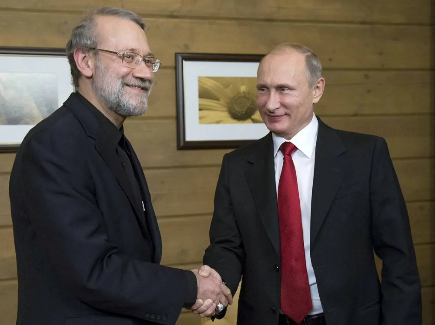 Russia's President Vladimir Putin (R) shakes hands with Iran's then parliament Speaker Ali Larijani as they meet after a session of the Valdai International Discussion Club in Sochi, Russia, October 22, 2015. (Reuters)