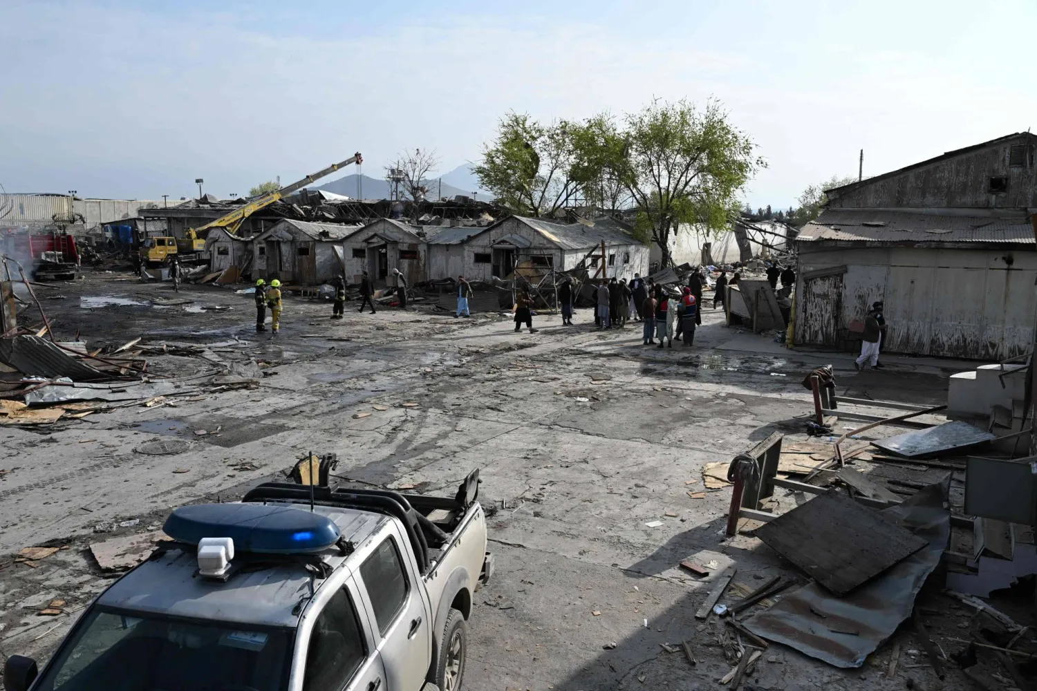 Taliban security personnel inspect the site after Pakistani airstrikes hit the Secondary Rehabilitation Services Center in Kabul on March 17, 2026. (Photo by Wakil KOHSAR / AFP)