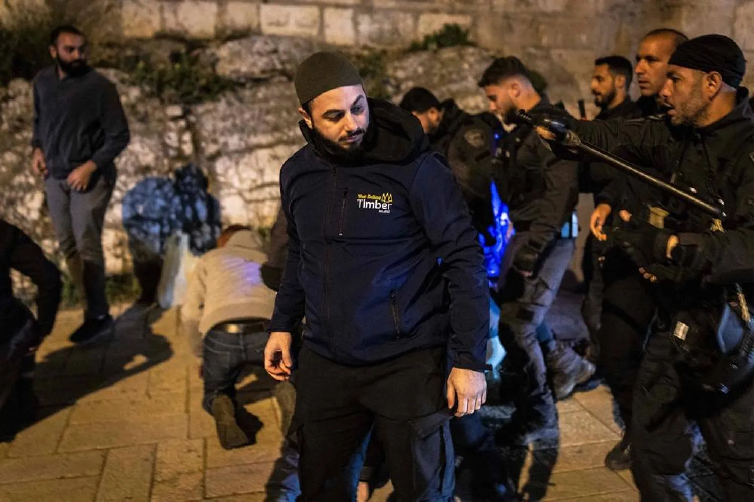  Israeli security forces disperse Muslim worshippers who were performing the nightly Taraweeh prayers during the Muslim holy month of Ramadan outside the old city walls of Jerusalem on March 17, 2026, while the al-Aqsa Mosque compound remains closed. (AFP)