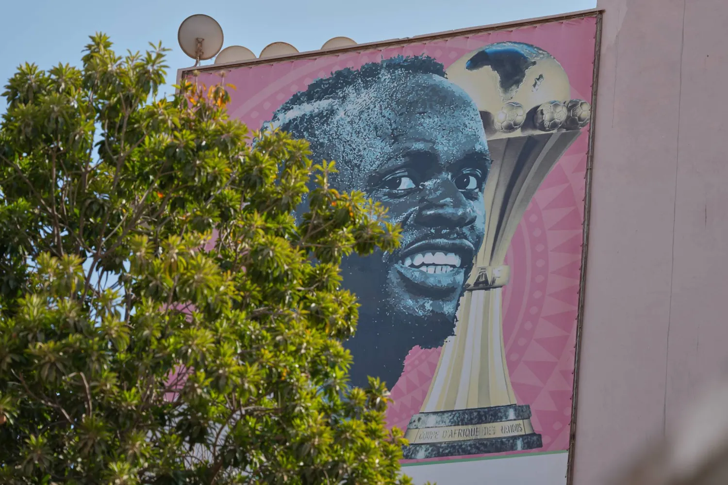 جدارية تحمل صورة القائد السنغالي ماني مع كأس أفريقيا (أ.ب)