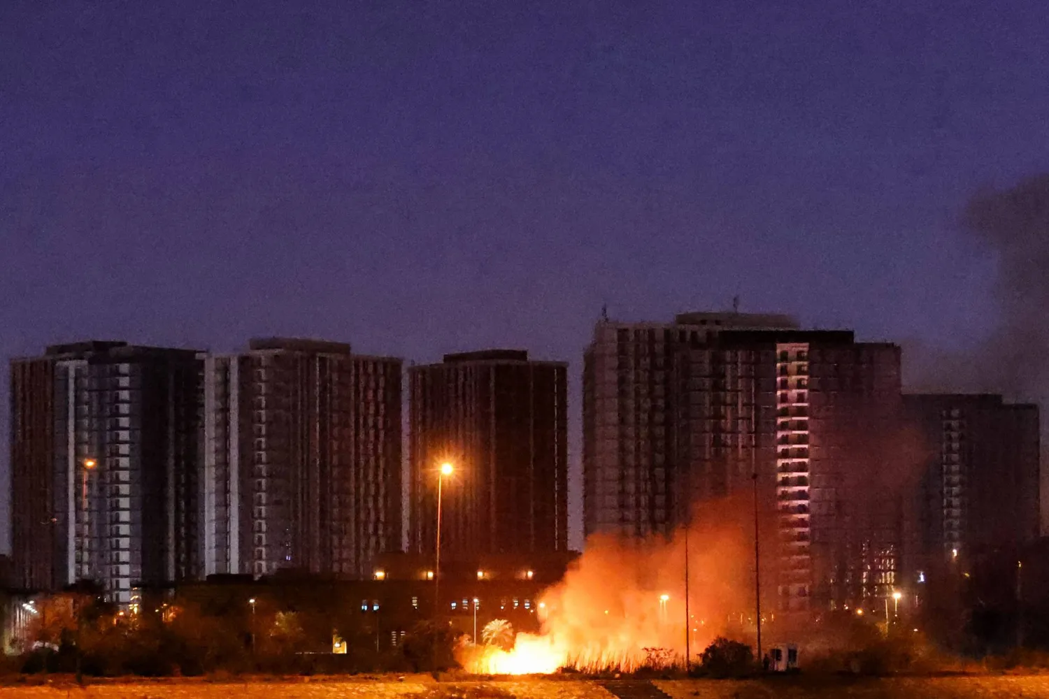A fire burns outside the grounds of the US Embassy headquarters in Baghdad's fortified "Green Zone" on March 17, 2026 following a drone and rocket attack according to security officials. (AFP)