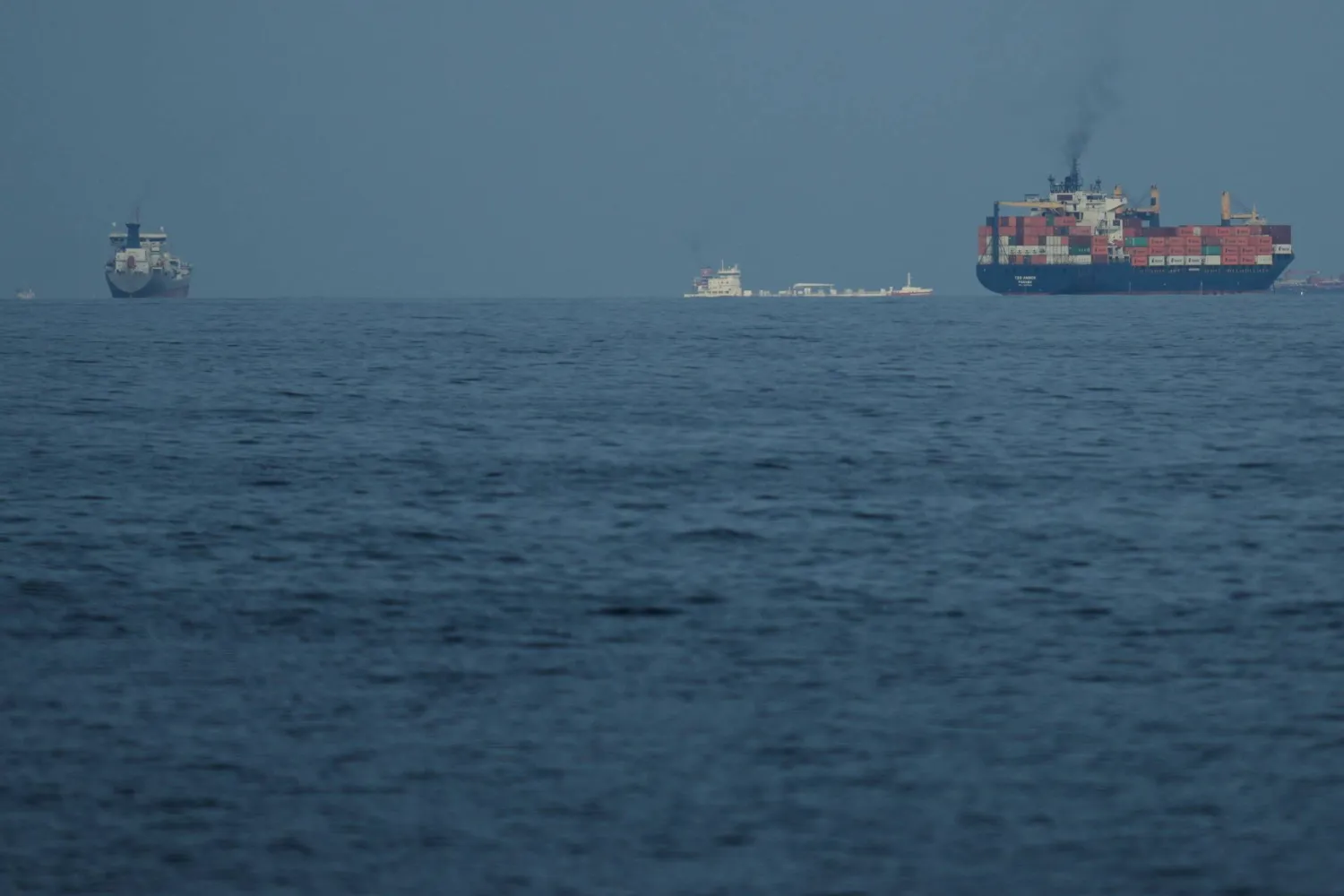 Ships line up in the Strait of Hormuz as seen from Khor Fakkan, United Arab Emirates, Wednesday, March 11, 2026. (AP Photo/Altaf Qadri)