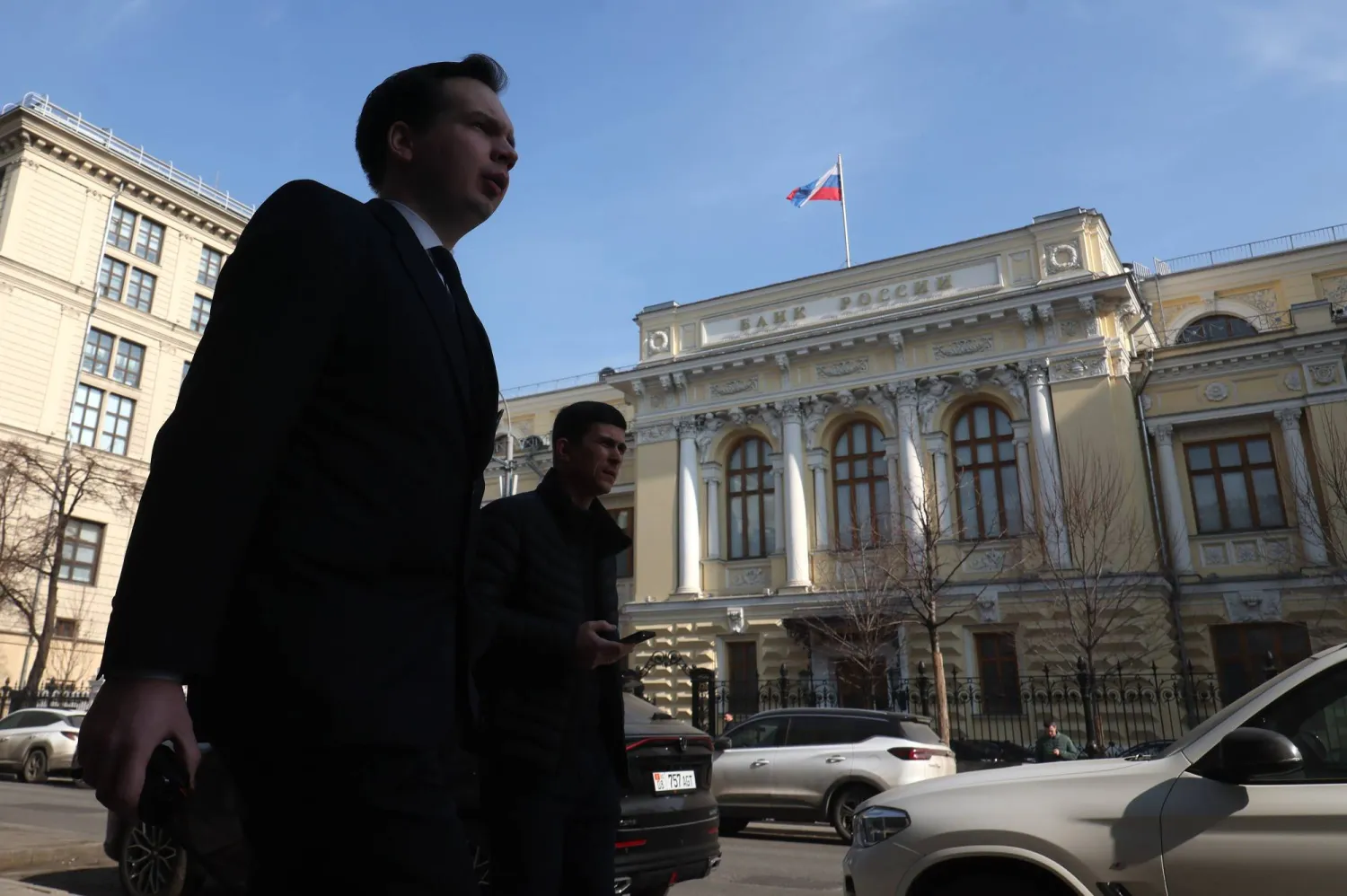 People walk in front of the Bank of Russia (Central Bank of the Russian Federation) headquarters in Moscow, Russia, 20 March 2026. EPA/MAXIM SHIPENKOV