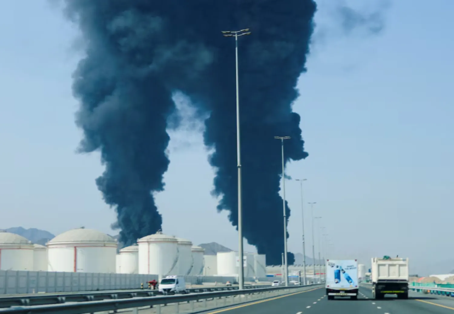 Smoke rises in the Fujairah oil industry zone, caused by debris after interception of a drone by air defenses, according to the Fujairah media office, amid the US-Israel conflict with Iran, in Fujairah, United Arab Emirates, March 14, 2026. REUTERS/Staff