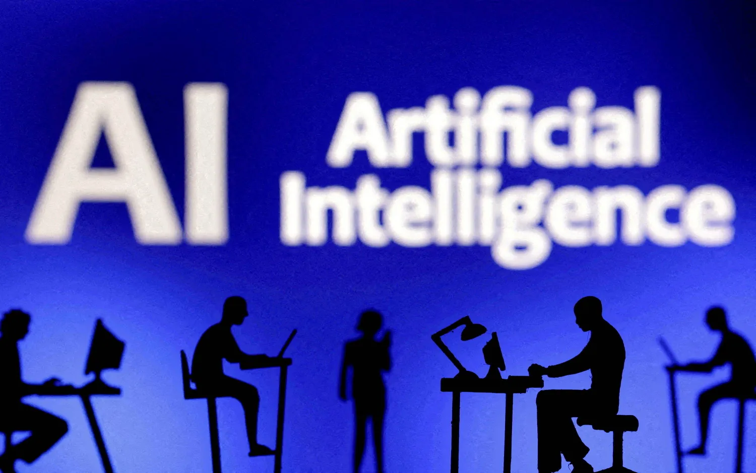 FILE PHOTO: Figurines with computers and smartphones are seen in front of the words "Artificial Intelligence AI" in this illustration created on February 19, 2024. REUTERS/Dado Ruvic/Illustration/File Photo