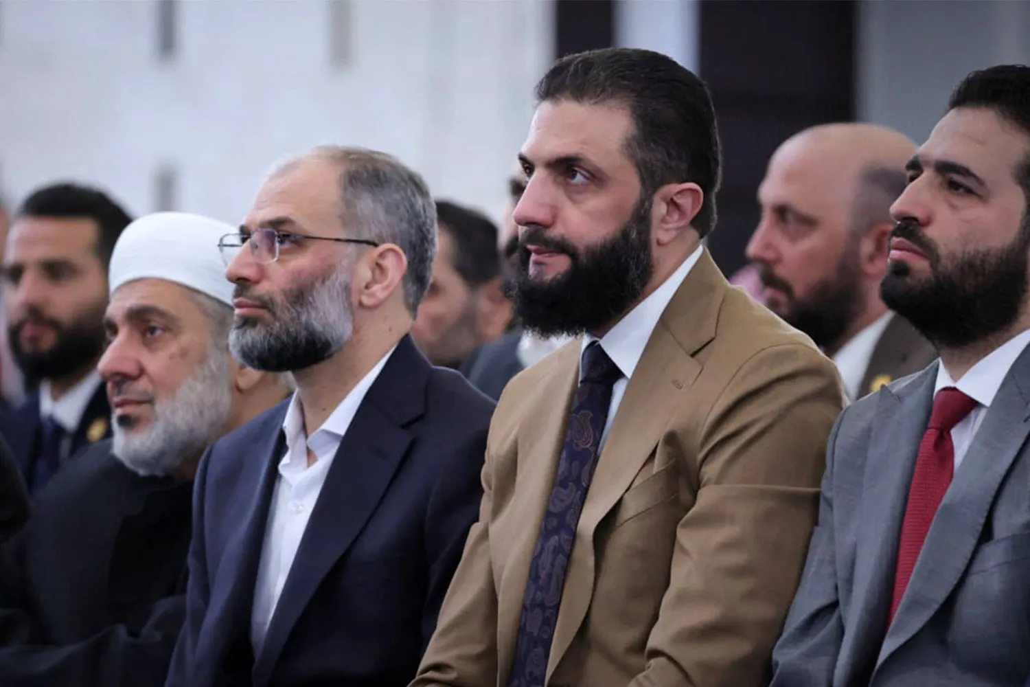 This handout photograph released by the official Syrian Arab News Agency (SANA) shows Syria's interim President Ahmed al-Sharaa (2nd-R) attending the early morning prayers for Eid al-Fitr, marking the end of the holy month of Ramadan, in Damascus on March 20, 2026. (SANA/AFP)