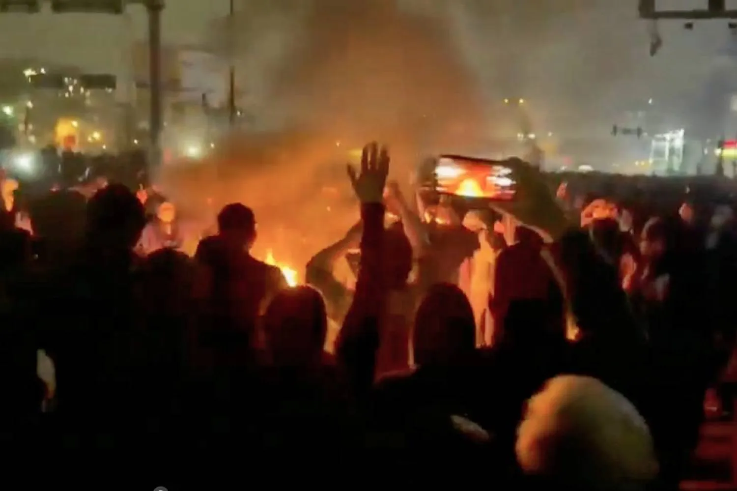 In this image from video circulating on social media, protesters dance and cheer around a bonfire as they take to the streets of Tehran, Iran, on Jan. 9, 2026. (UGC via AP, File) 