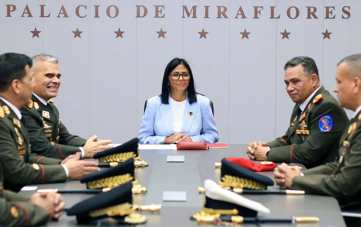 Handout picture released on March, 20, 2026 by the Venezuelan presidency press office showing Venezuela's interim President Delcy Rodriguez( C) during a meeting with outgoing Defense Minister Padrino Lopez (2nd L) and the new Defense Minister General-in-Chief Gustavo Gonzalez Lopez (2nd R) at the Miraflores presidential palace in Caracas, on March 19, 2026. (Handout / Venezuelan Presidency / AFP) 