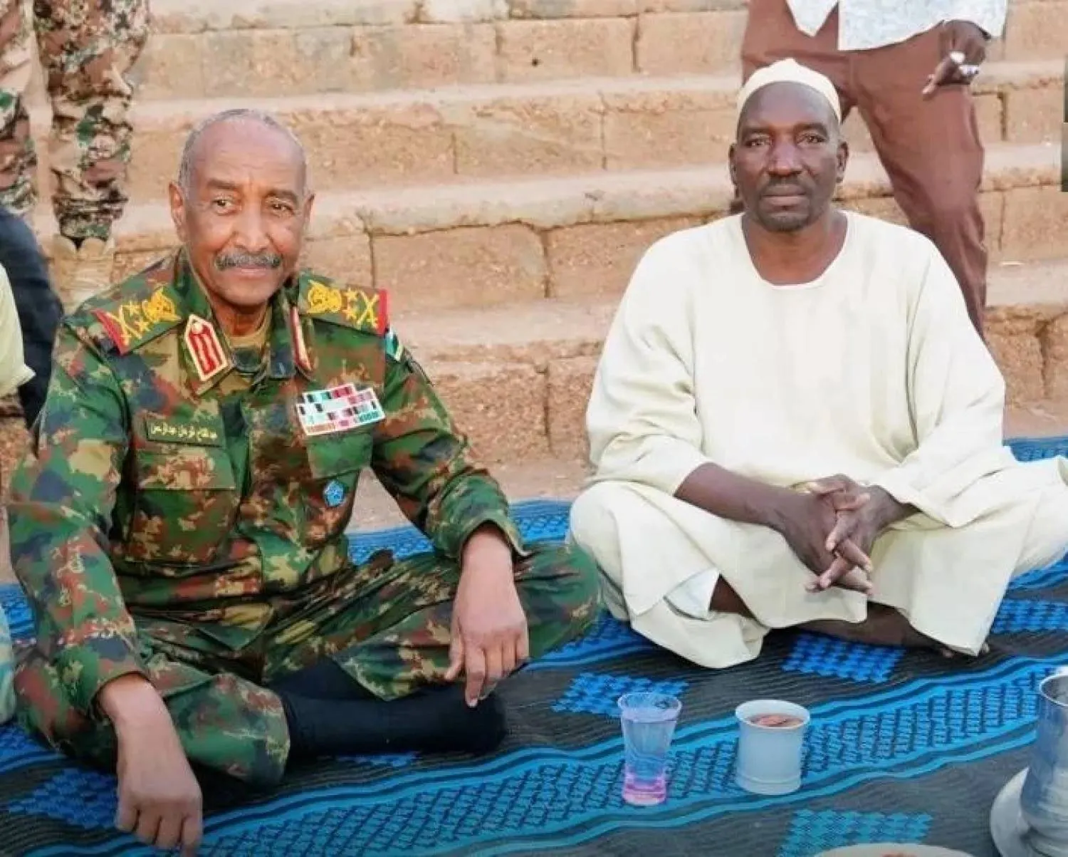 Sudanese army chief Abdel Fattah al-Burhan attends a group iftar with members of the community police in the final days of Ramadan. (Sudanese Armed Forces – Facebook). 