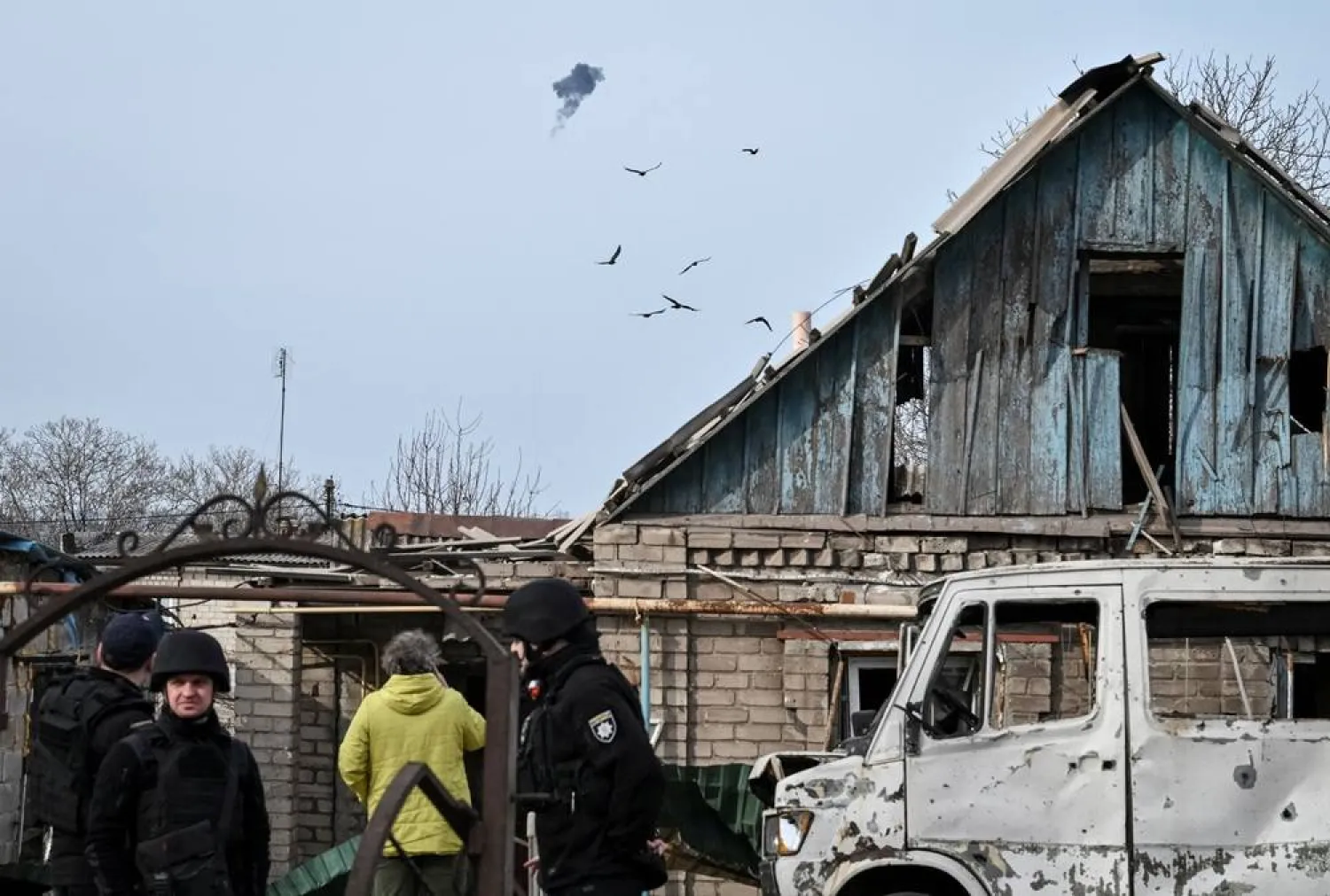  Ukrainian servicemen hit a Russian drone as police officers work at the site of a building hit by a Russian drone strike, amid Russia's attack on Ukraine, in Zaporizhzhia, Ukraine March 21, 2026. (Reuters)