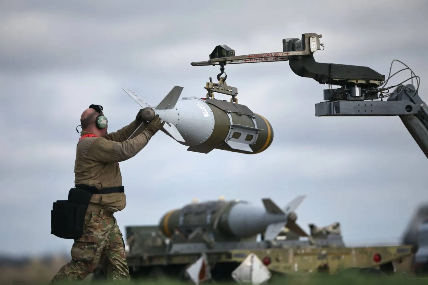  US Military personnel take away Joint Direct Attack Munitions (JDAMs), removed from a US Air Force B-1 Lancer bomber at RAF Fairford in southwest England on March 15, 2026. (AFP)