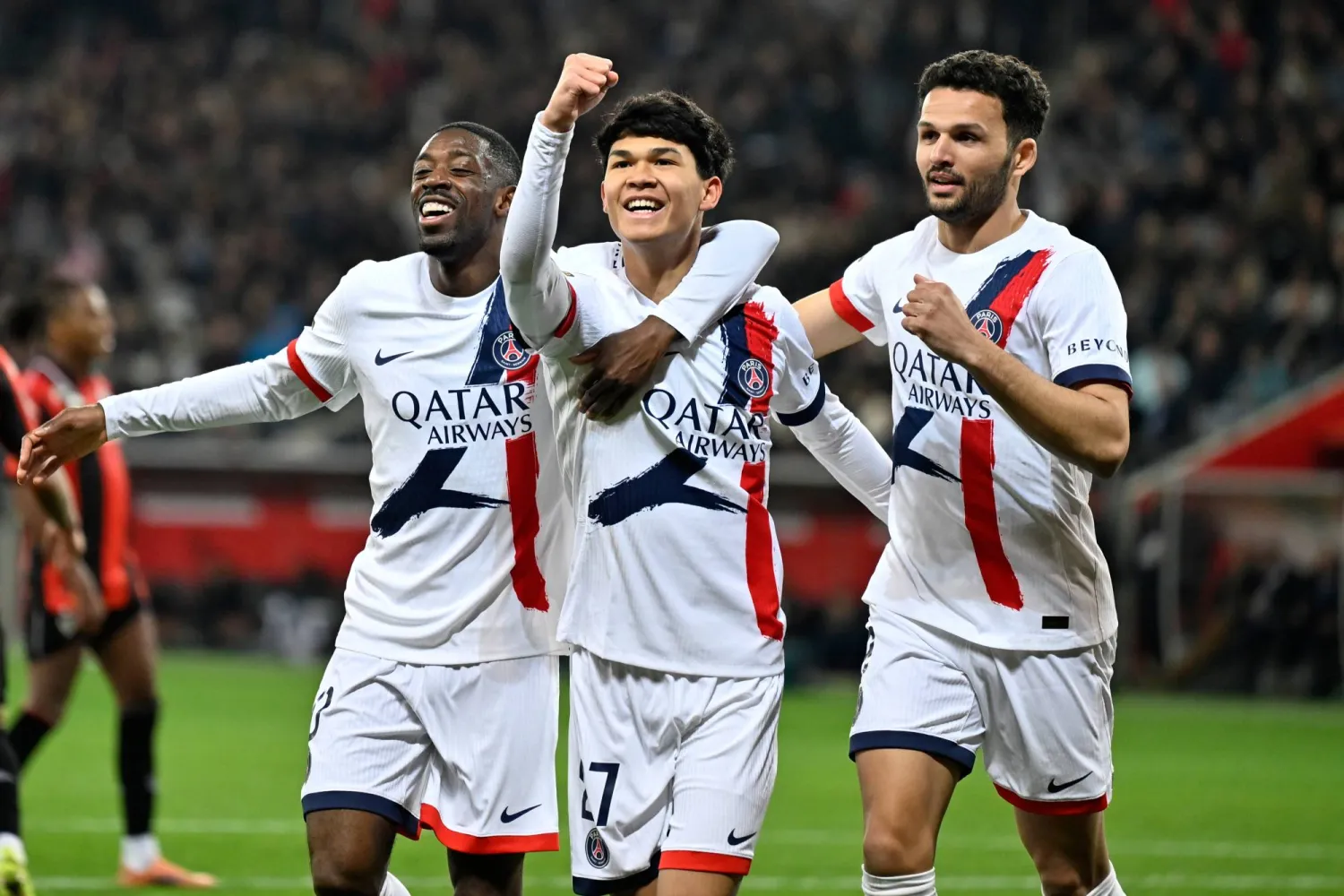 PSG's Pedro Fernandez, center, celebrates after scoring his side's third goal during the French League One soccer match between Nice and Paris Saint-Germain in Nice, France, Saturday, March 21, 2026. (AP Photo/Philippe Magoni)