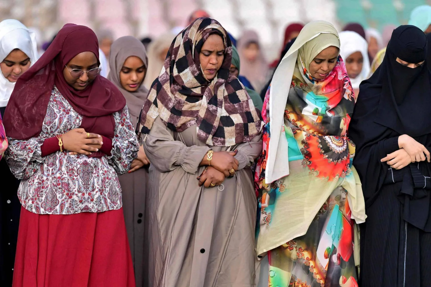 Women Muslim worshippers gather for the early morning prayers for Eid al-Fitr, marking the end of the holy month of Ramadan, at a stadium in Sudan's eastern Red Sea port city of Port Sudan on March 20, 2026. (Photo by Ibrahim ISHAQ / AFP)