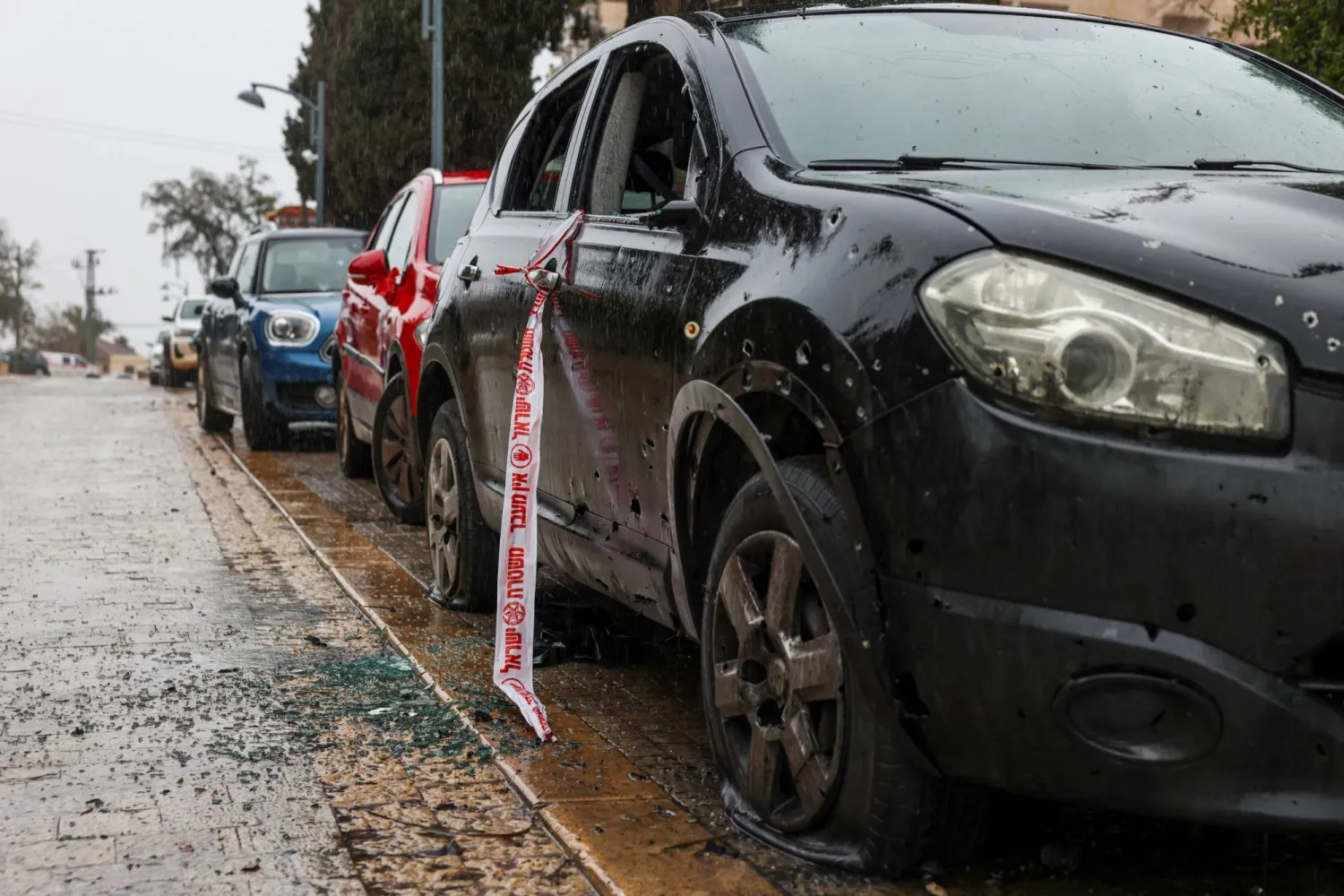 A damaged vehicle is seen in a residential area after impact amid escalation between Hezbollah and Israel, in northern Israel, March 21, 2026. REUTERS/Tyrone Siu