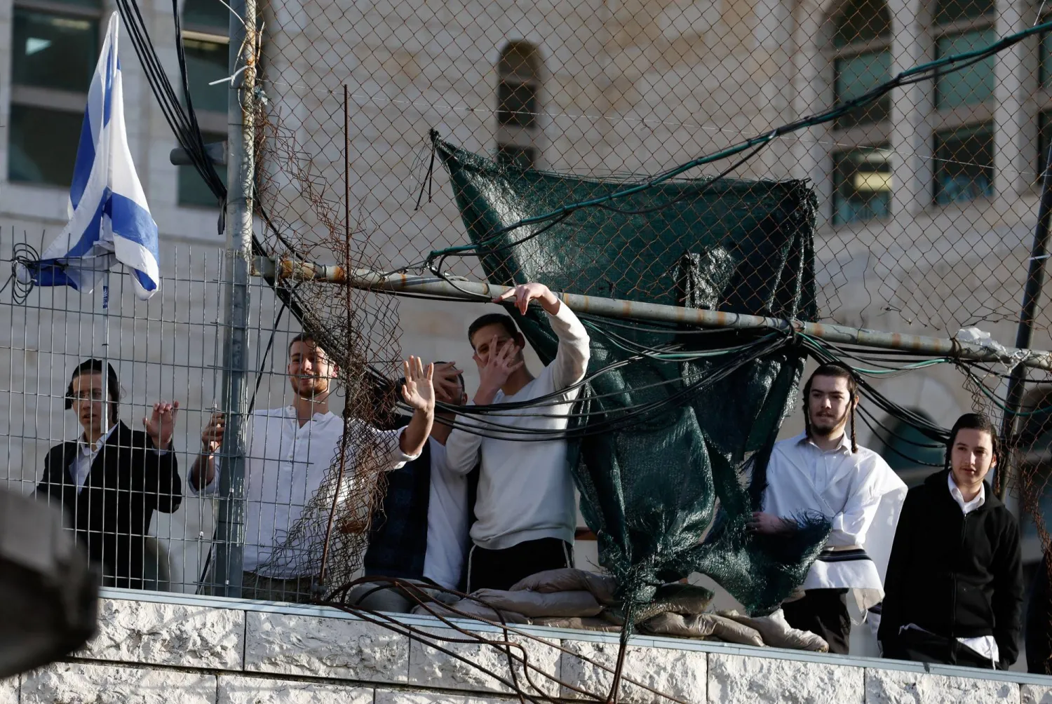 Israeli settlers gesture during a weekly settlers' tour in Hebron, in the Israeli-occupied West Bank, February 7, 2026. REUTERS/Mussa Qawasma