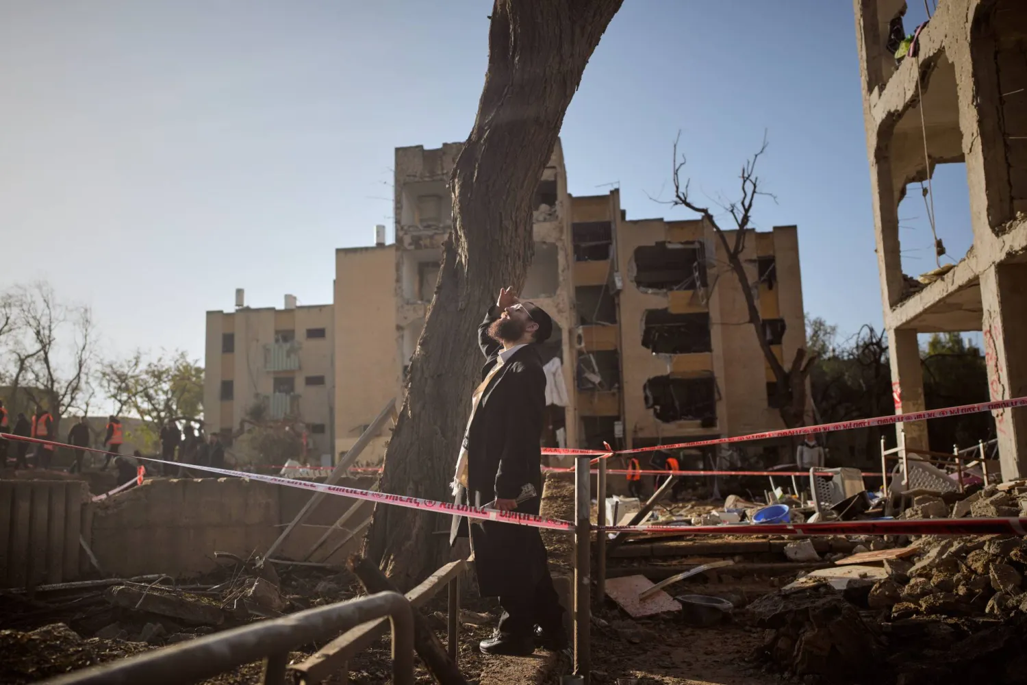 A man looks at residential buildings damaged by an Iranian missile strike in Arad, southern Israel, Sunday, March 22, 2026. (AP Photo/Ohad Zwigenberg)