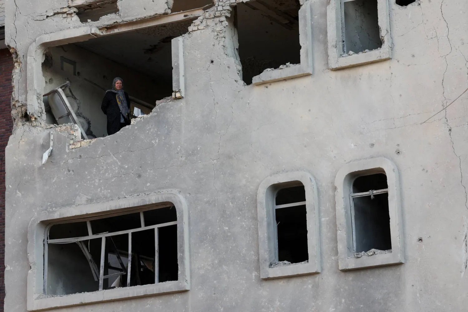 A woman stands inside a destroyed building, amid the US-Israeli conflict with Iran, in Tehran, Iran, March 21, 2026. Reuters/Alaa Al-Marjani