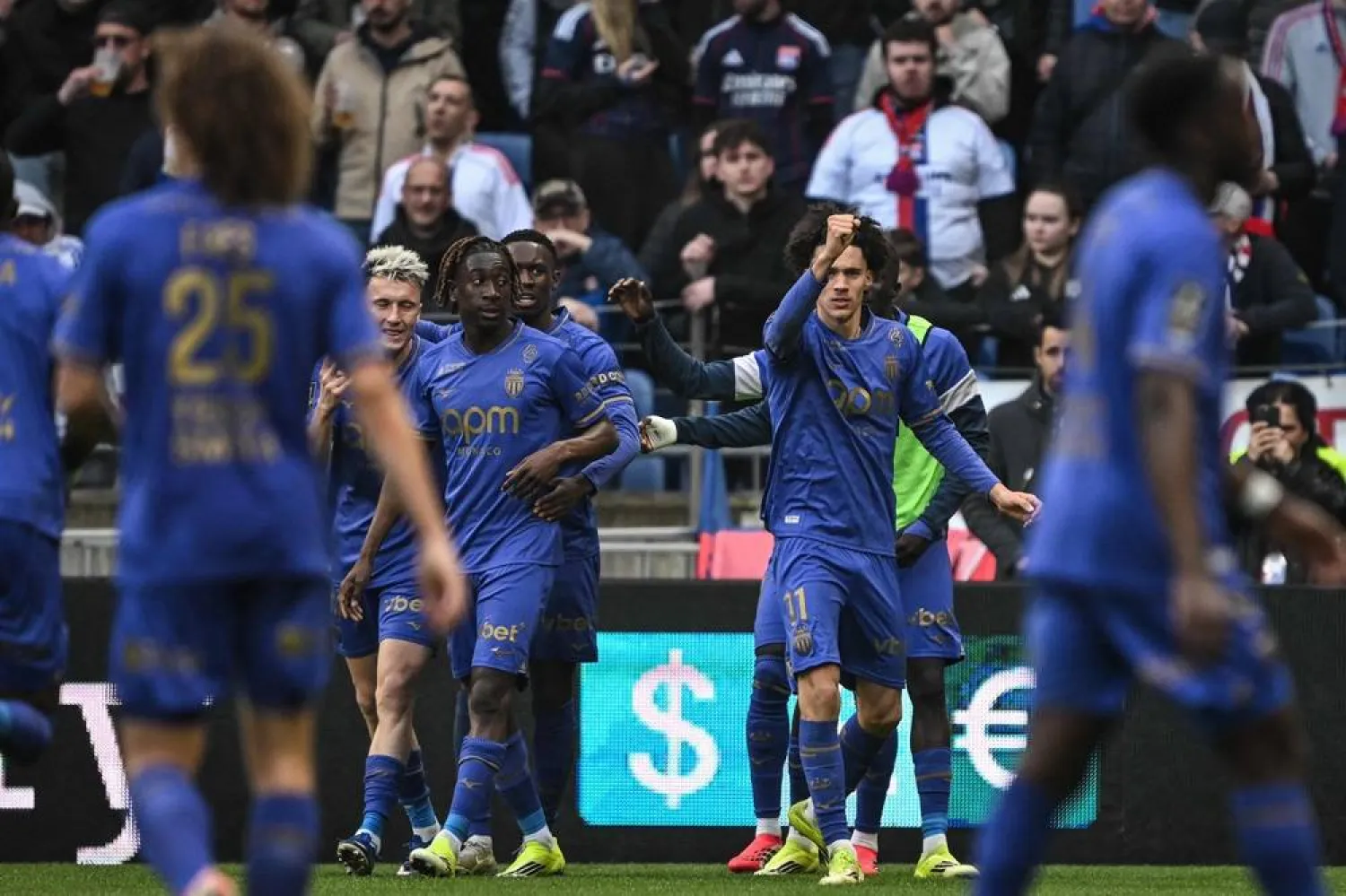  Monaco's French midfielder #11 Maghnes Akliouche (R) celebrates with his teammates after scoring a goal during the French L1 football match between Olympique Lyonnais (OL) and AS Monaco (ASM) at the Groupama Stadium in Decines-Charpieu, central-eastern France on March 22, 2026. (AFP) 